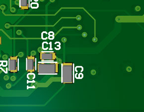 Cluster of capacitors supporting a regulator on the opposite side. Positions have been optimized for best decoupling performance over reflow profile.